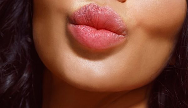 Close up, natural lips. Beautiful and fresh young woman. Kiss.